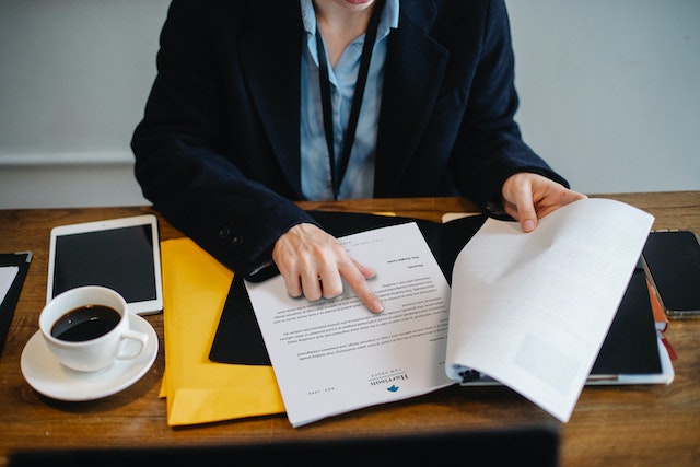 Cropped businesswoman working with documents in an office.