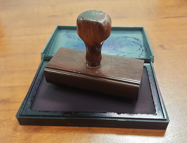 A rubber stamp on a wooden desk.