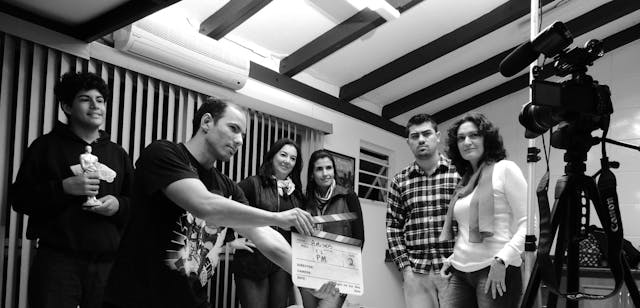 A group of people record a movie.