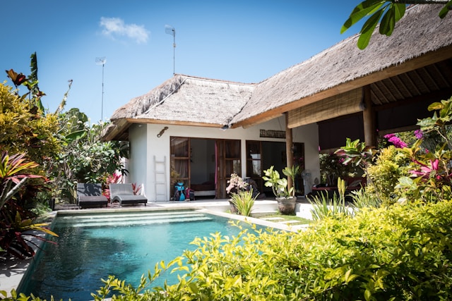 A close-up of a house with a mini swimming pool and garden.
