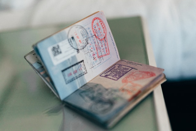 A close-up of a passport with multiple stamps.