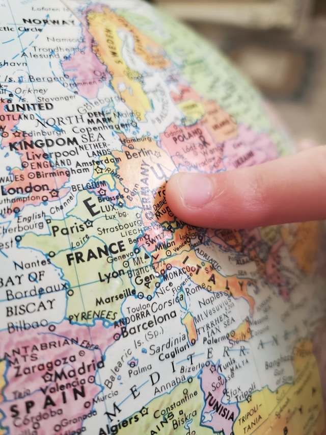 A person points at Germany on a globe.