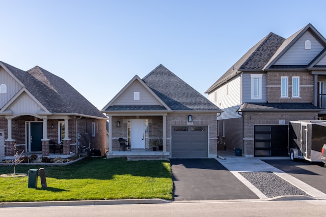 Multiple row houses with a front yard and driveway.